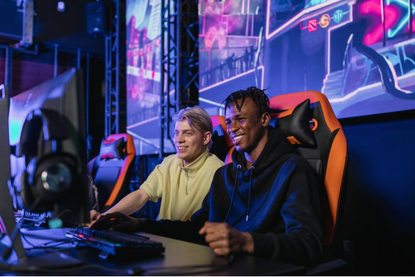 Two boys smiling while playing in an eSports tournament