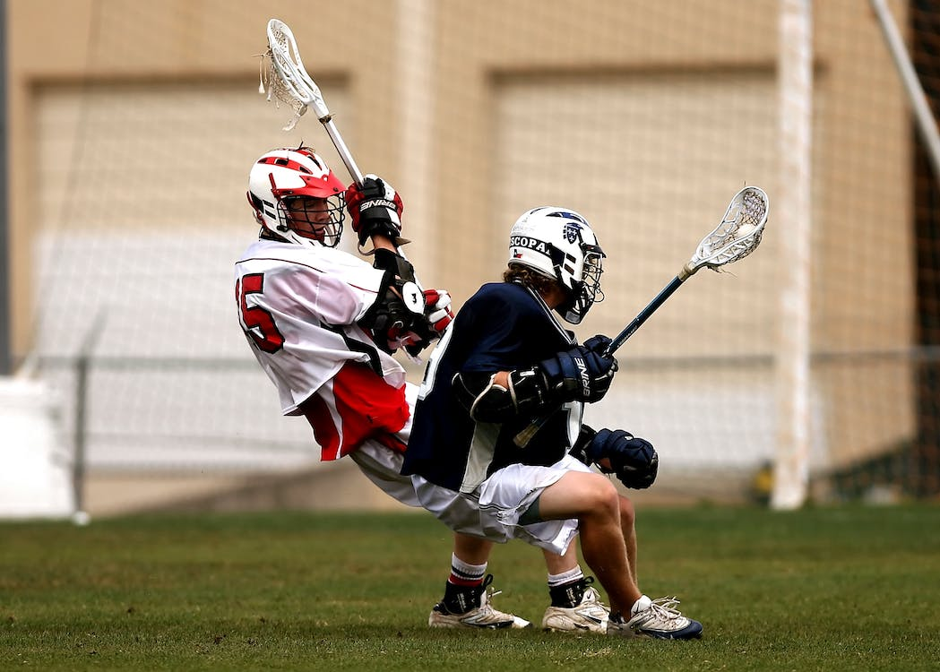 Two players playing lacrosse